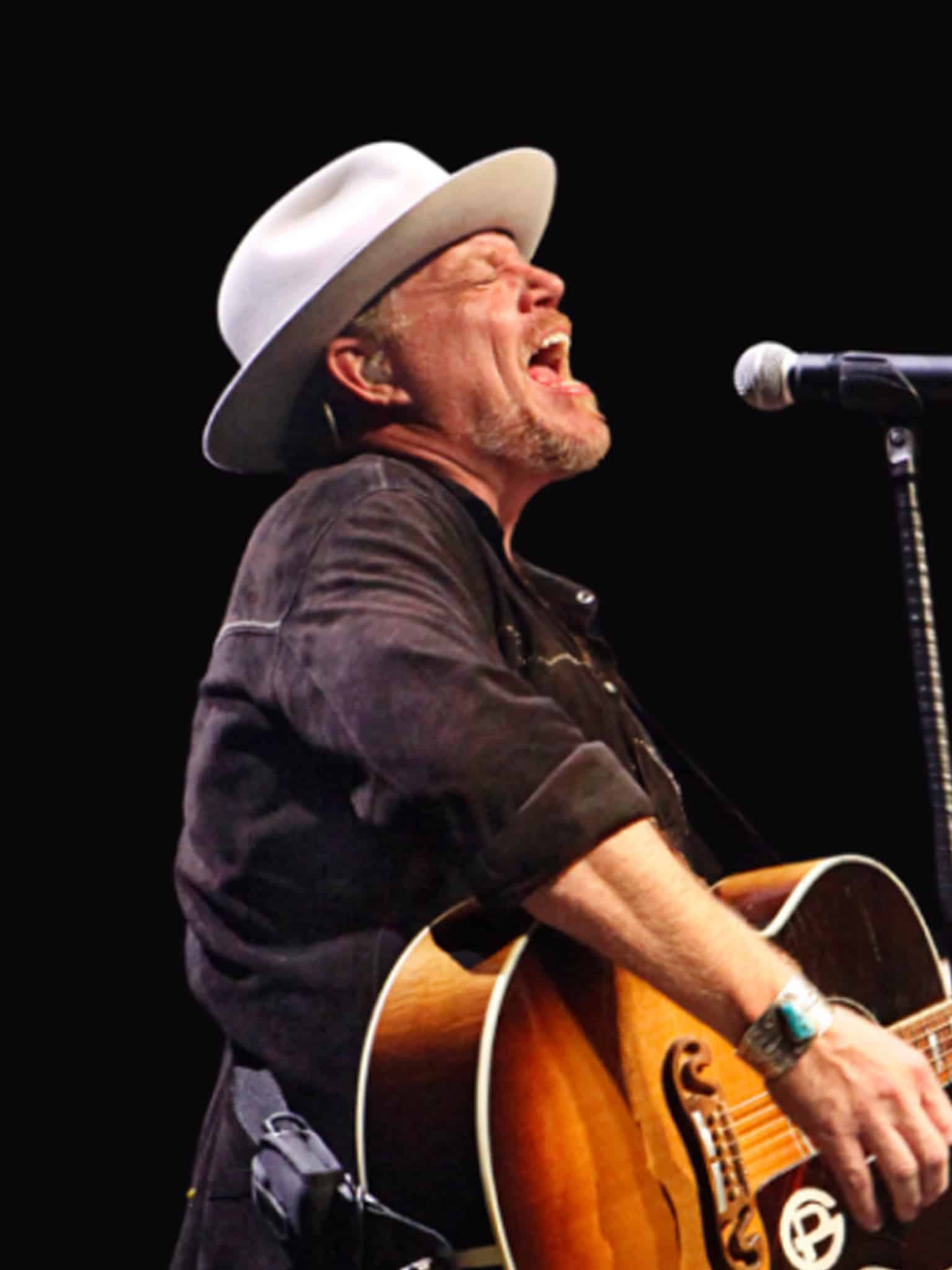 Musician Pat Green performing on stage with a guitar